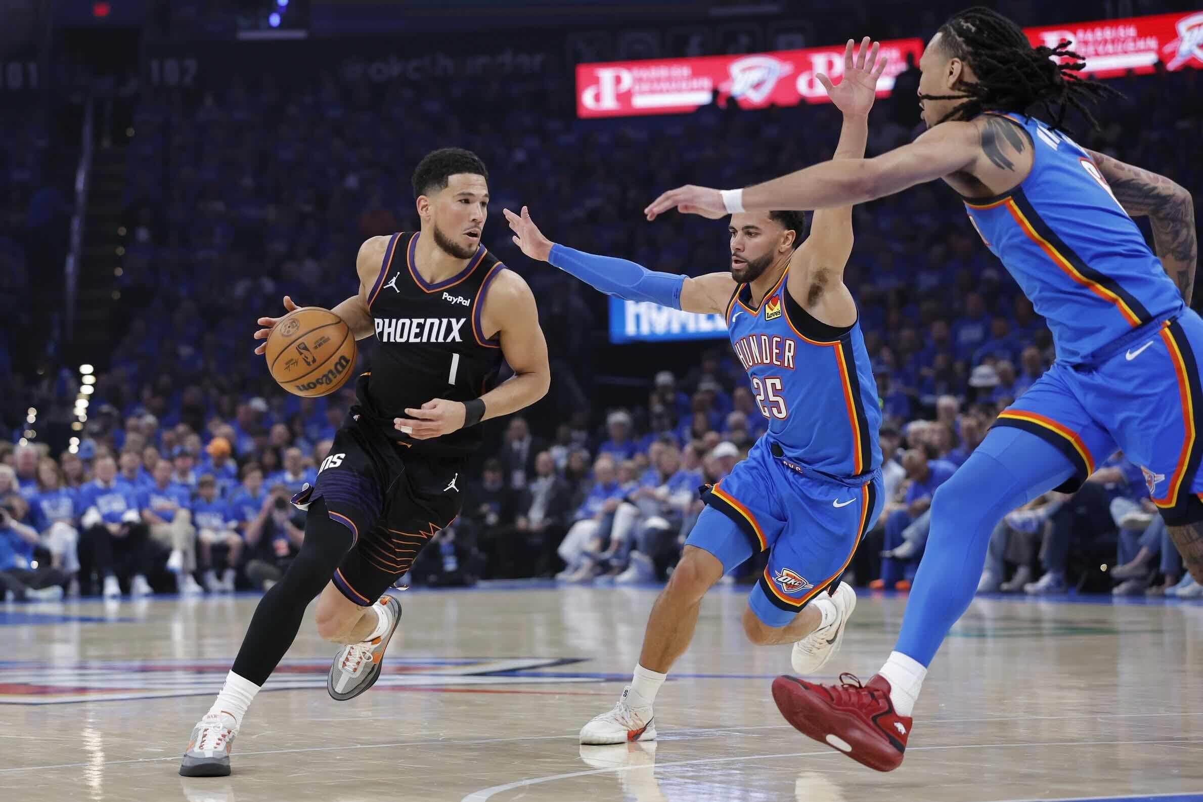 Devin Booker tries to create against the Thunder's suffocating defensive pressure in Game 1, symbolizing the Suns' offensive struggles in the opening of the series.